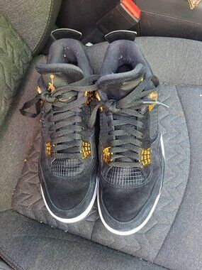 Nike Air Jordan 4 Retro Royalty sneakers featuring black suede and metallic gold
